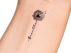 a small dandelion tattoo on the wrist