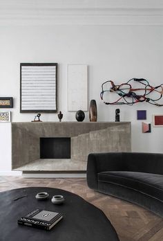 a living room filled with furniture and a fire place in the middle of the room