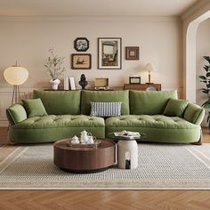 a living room with green couches and pictures on the wall above them, along with other furniture