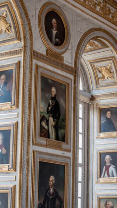 an ornate room with paintings on the wall