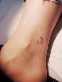 a small moon and crescent tattoo on the side of a foot, with a black outline