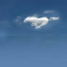 an airplane flying in the sky with a cloud shaped like a heart