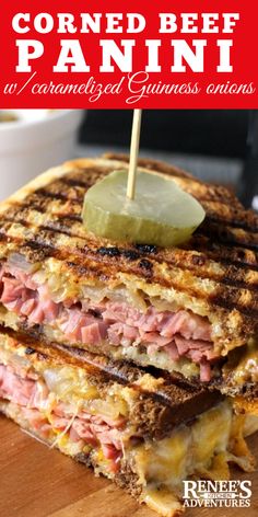 corned beef panini is cut in half with a pickle on top