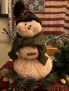 a knitted snowman sitting on top of a table