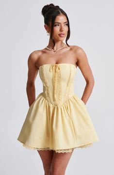 Fall in love with the Evie dress, a flirty mini with a super full skirt made with tulle for extra volume. This strapless style has a boned bodice for an extra snatched look, complete with ribbon to the bust and lace up back. Dress her up with effortless waves, pointed heels and metallic jewellery.    Colour: Lemon.  Non-stretch cotton blend fabric.  Fully lined.  Full skirt with tulle and gathered detail at waist.  Boned bodice with v-shape hem.  Strapless.  Ribbon tie at bust.  Lace trim detail Lace Up Back Dress, Effortless Waves, Maxi Dress Sale, Pointed Heels, Sparkle Dress, Dresses By Length, Formal Dresses Prom, Back Dress, Flowy Dress