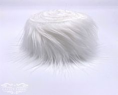 a white fur hat on a white background