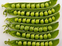 pea pods are arranged on top of each other