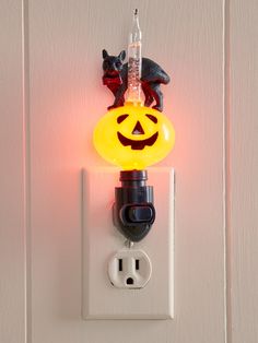 an electrical outlet with a halloween light on it