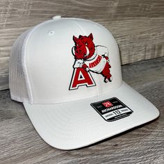 Our Pvc Patch Is A Waterproof, Rugged, And Clean Looking Design. You Can Bet That This Patch Will Look Vibrant For Years To Come. We Only Use The Highest Quality Products And Headwear. We Believe That Our Pvc Patches Beat Out Any Other Type Of Patch Offered On A Hat. Design: Arkansas Razorbacks- Leaning A Hat: Richardson 112 Color: White Structured, Six-Panel, Mid-Profile 60/40 Cotton/Polyester Adjustable Plastic Snapback Pre-Curved Contrast Stitched Visor Hat Size: 7 - 7 3/4 White Curved Bill Trucker Hat For Baseball Season, White Snapback Hat With Curved Bill For Baseball Season, White Baseball Cap For Fan Merchandise, White Flat Brim Fitted Hat For Baseball Season, White Snapback Hat For Game Day, White Curved Bill Hat For Baseball Season, White Casual Baseball Cap For Fans, White Flat Brim Trucker Hat For Sports Events, Casual White Baseball Cap For Fans