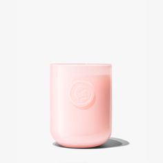 a pink candle sitting on top of a white table