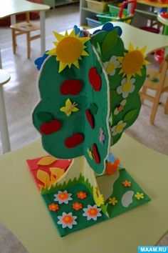 an arts and crafts project made out of paper with sunflowers on it in a classroom