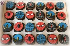 cupcakes decorated with spiderman faces are in a box