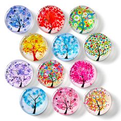 six different colored buttons with trees painted on them