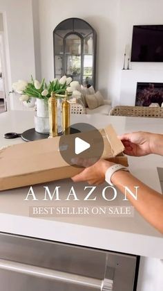 a woman opening a box on top of a counter