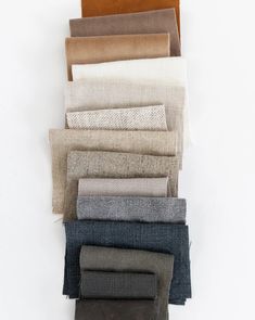 a stack of different colored linens sitting on top of each other in front of a white background