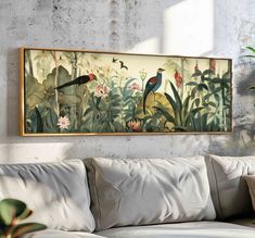 a painting hanging on the wall above a couch