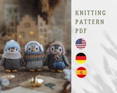 three knitted owls sitting next to each other on top of a table with flags and buildings in the background