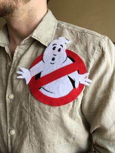 a man wearing a shirt with a ghost sticker on it