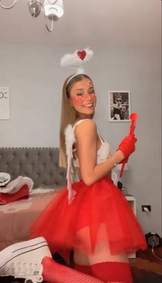 a woman in a red tutu skirt and white top is posing for the camera