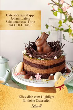 there is a cake on the table with chocolate decorations and flowers around it that reads, easter treat tip