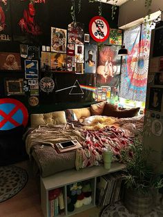 a bed room with a neatly made bed and lots of pictures on the wall