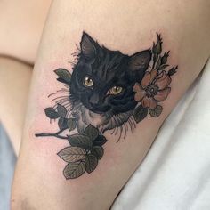 a black cat with flowers on its thigh