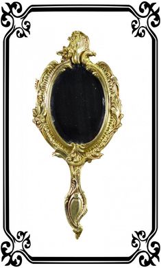 an ornate gold frame with a black mirror