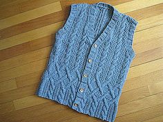 a blue sweater sitting on top of a wooden floor