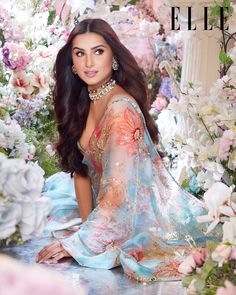 an image of a woman sitting in front of flowers