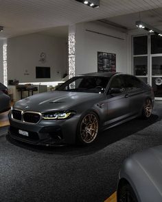 two cars parked in a showroom next to each other