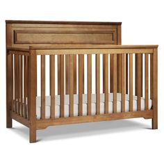 a wooden crib with white sheets on the bottom and side rails, against a white background