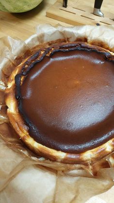 a chocolate pie sitting on top of a piece of wax paper next to a knife