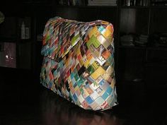 a multicolored bag sitting on top of a wooden table next to a bookshelf