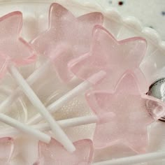 some pink and white lollipops on a plate