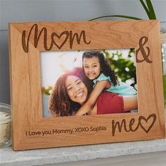 a wooden frame with the words mom and me on it