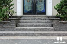 the steps lead up to the front door of a house with decorative glass panels on it