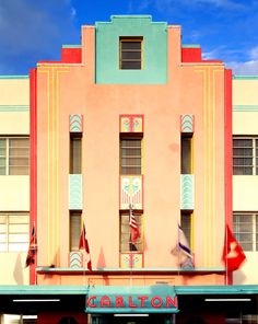 an old building with flags flying in the wind