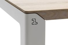 a close up of a wooden table with metal legs and a white frame on the top