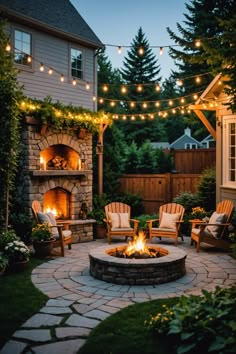 an outdoor fire pit surrounded by chairs and string lights