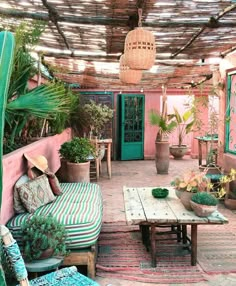 an outdoor patio with potted plants and furniture