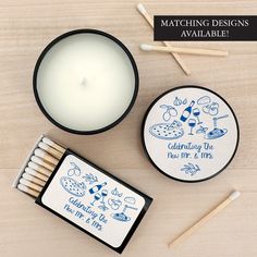 matches and match box on wooden table next to candle with matching designs available for purchase