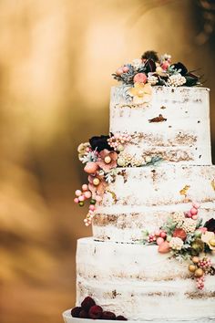 a white wedding cake with flowers on top