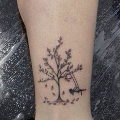 a small tree tattoo on the ankle