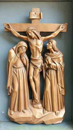 the crucifix has three people standing around it