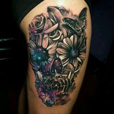 a woman's thigh with a skull and flowers on it