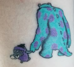 a woman with a tattoo on her stomach is holding the arm of a stuffed animal