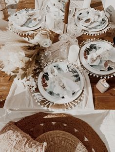 the table is set with plates and napkins