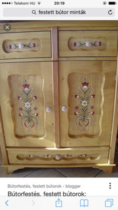 a wooden cabinet with embroidered designs on it