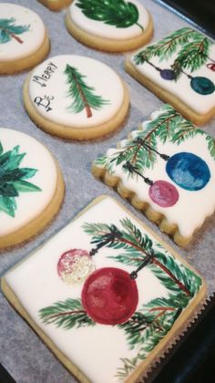 decorated cookies are sitting on a cookie sheet