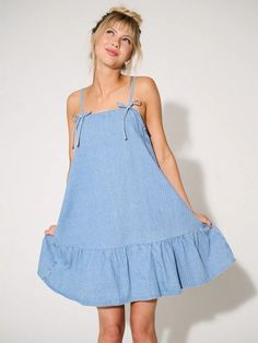 Chic Bow Denim Mini Dress: Your Summer Style Essential Cotton Mini Sundress With Tie Straps, Cotton Mini Dress With Tie Straps For Brunch, Cotton Sundress With Tie Straps, Mini Length, Cotton Sundress With Tie Straps In Mini Length, Chic Summer Sundress For Picnic, Trendy Summer Mini Dress With Tie Straps, Trendy Mini Dress With Tie Straps For Summer, Cotton Mini Dress With Tie Back For Casual Wear, Casual Summer Mini Dress For Picnic